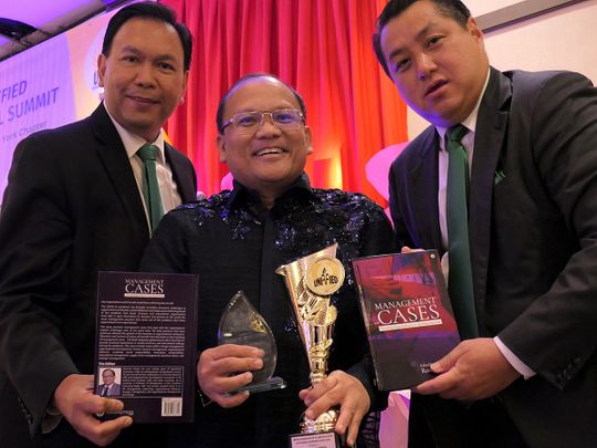 dr-rommel-sergio-with-award-and-book-in-NY-1661005746292