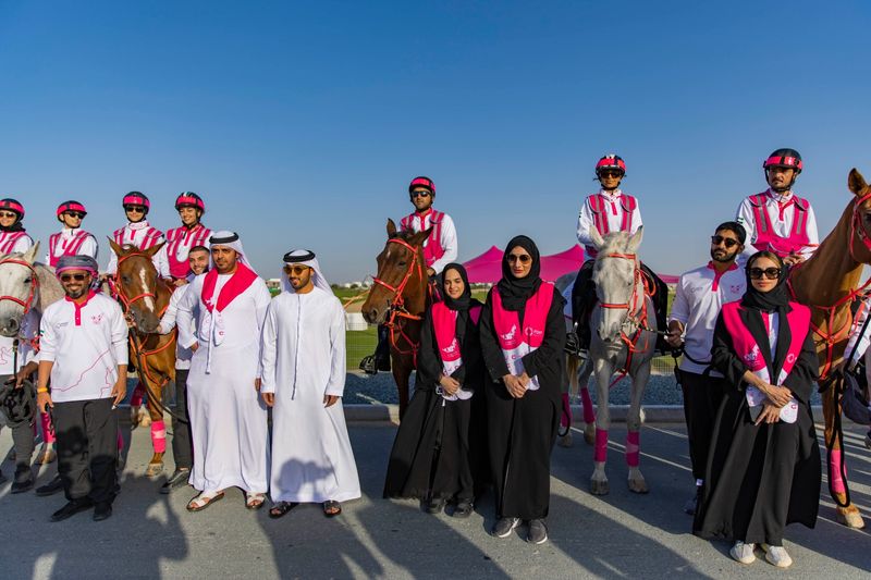 Group image of The Pink Caravan riders with Sheikh Abdullah bin Majid Al Nuaimi, Director General of Citizens Affairs Office in Ajman
